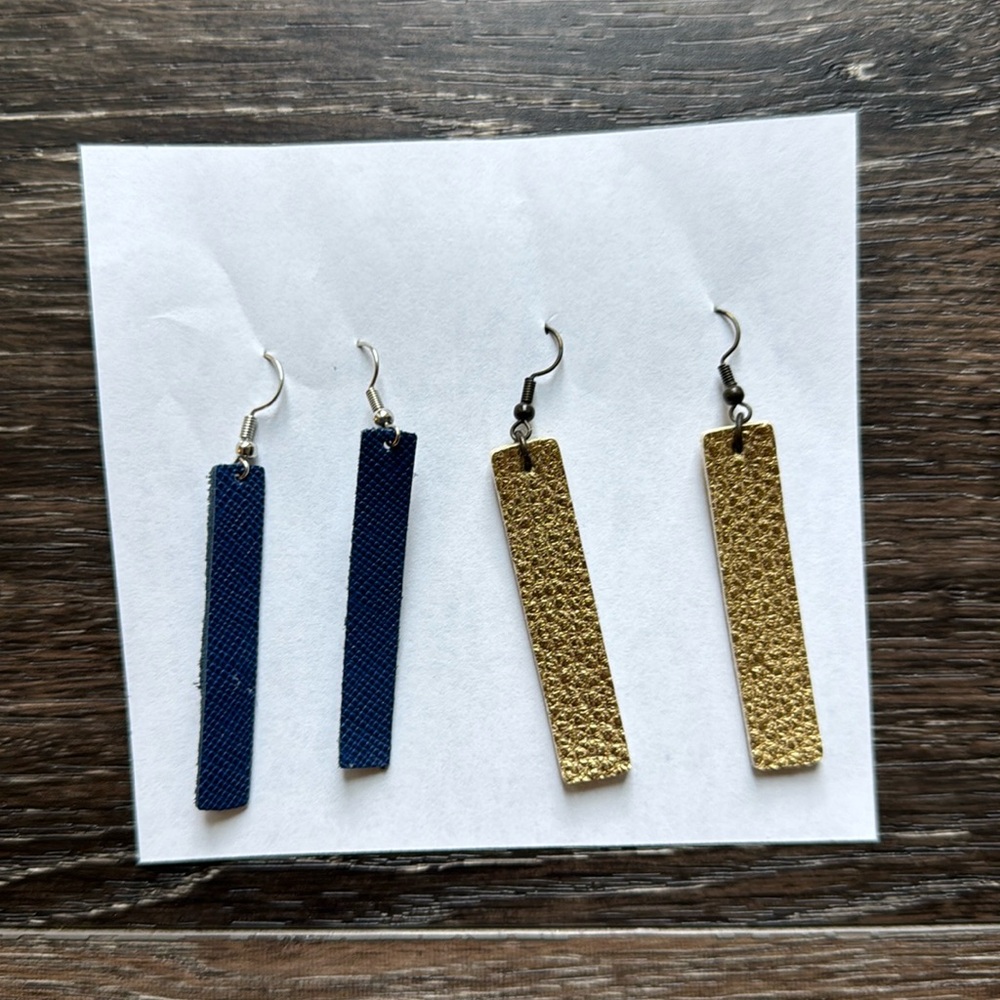 Two pairs of handmade leather earrings, gold and navy blue
